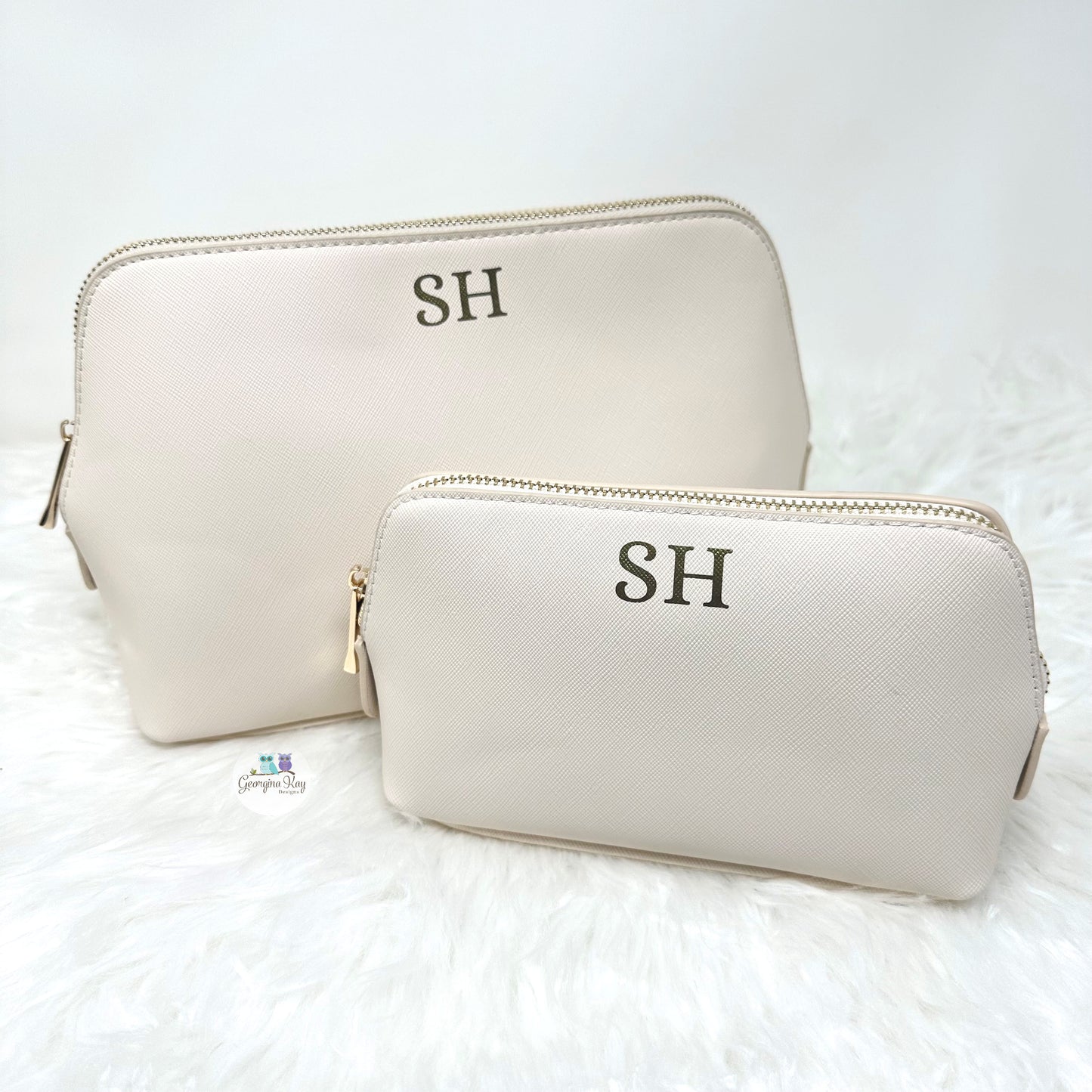 Two beige makeup bags with 'SH' initials on a white background