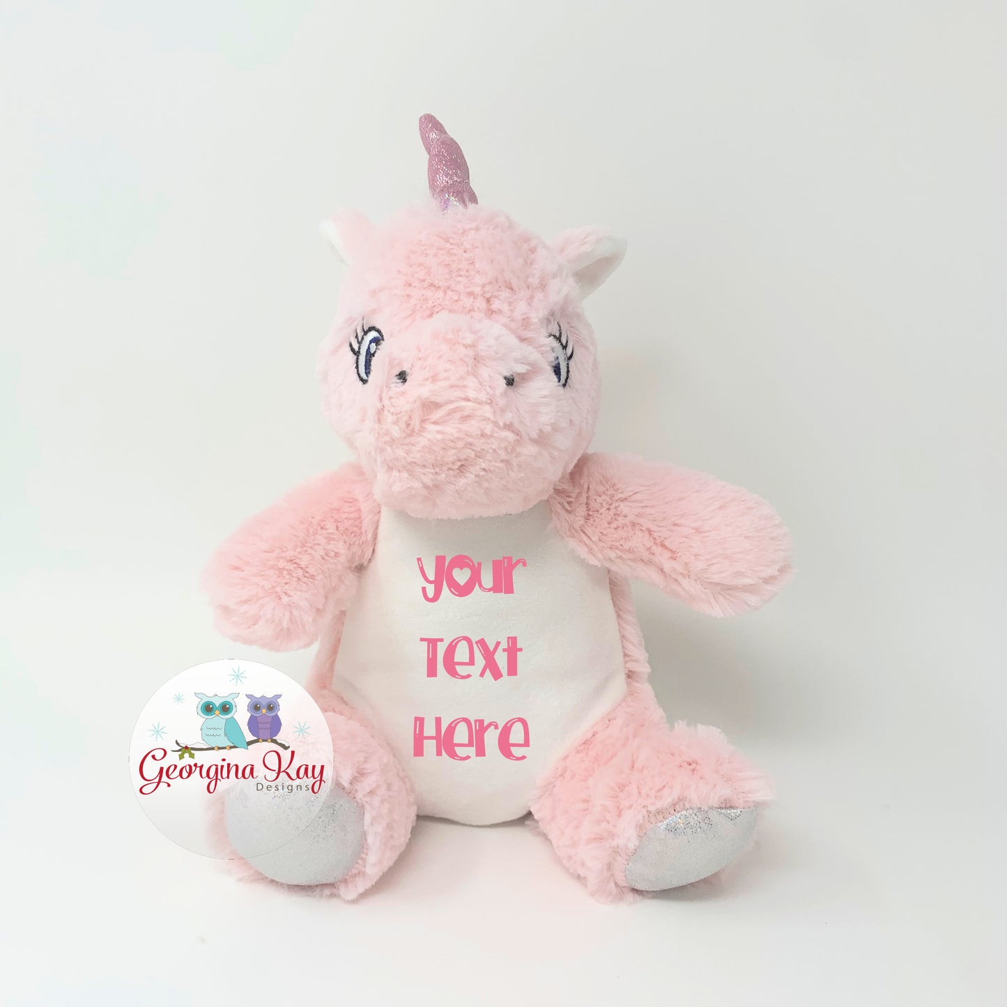 Pink plush unicorn toy with customizable text on a white background