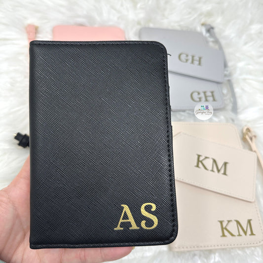 Black leather passport cover with initial personalised on the bottom right corner with the initials AS
