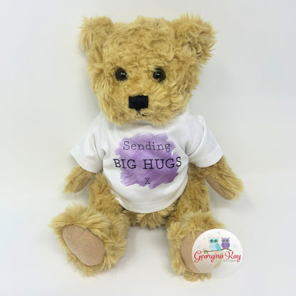 Teddy bear wearing a white shirt with purple text on a white background