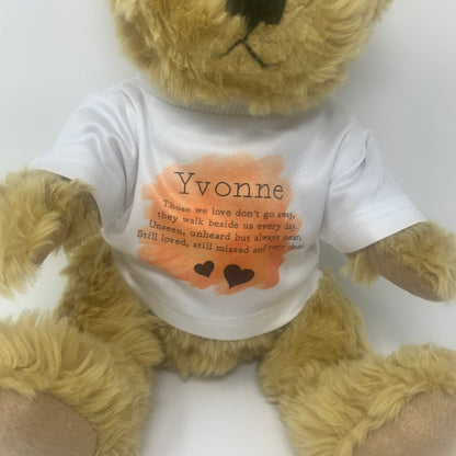 Teddy bear wearing a white shirt with text and a heart design on a white background