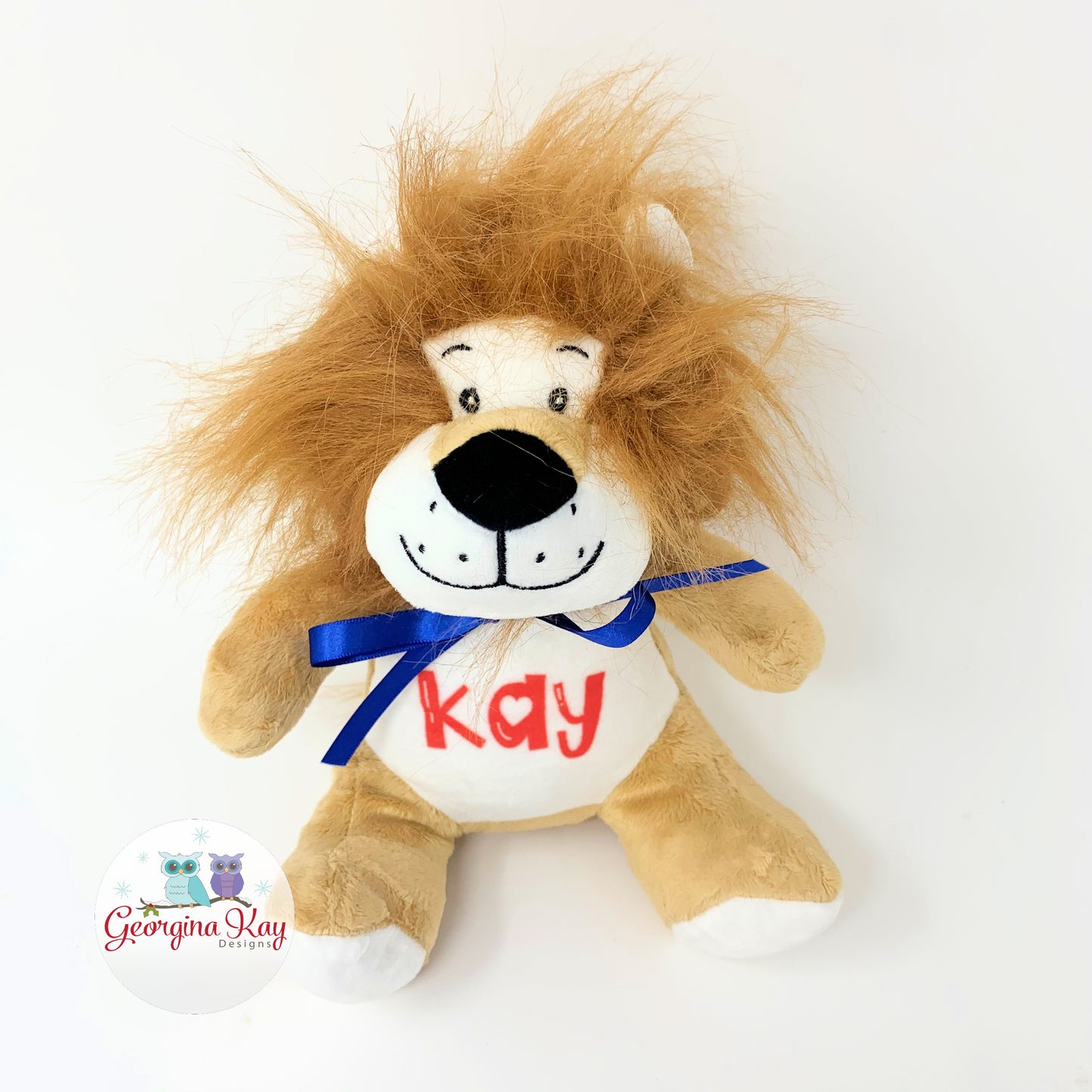 Plush lion toy with 'Kay' on a white background