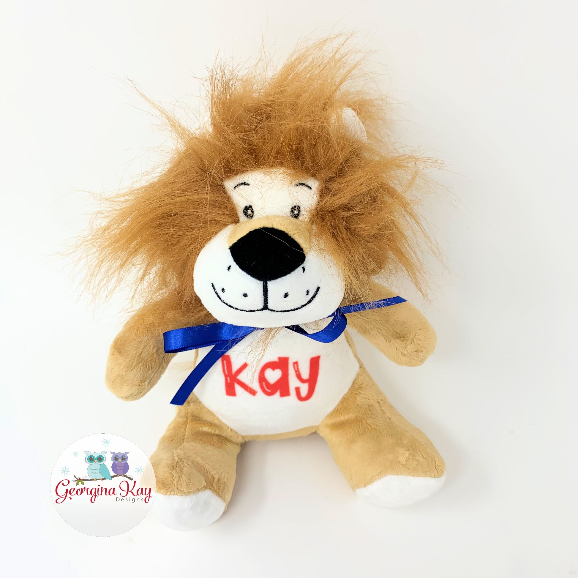 Plush lion toy with 'Kay' on a white background