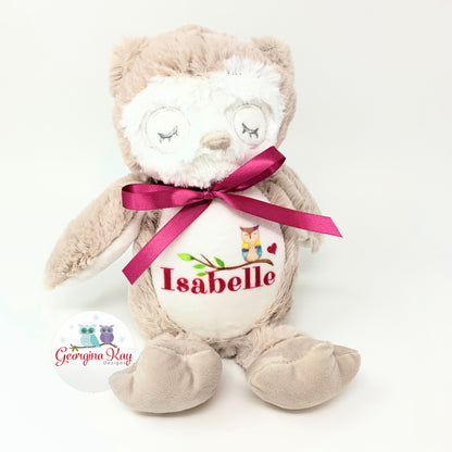 Plush owl toy with a pink ribbon and personalized name on a white background