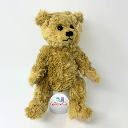Brown teddy bear with a visible brand logo on a white background