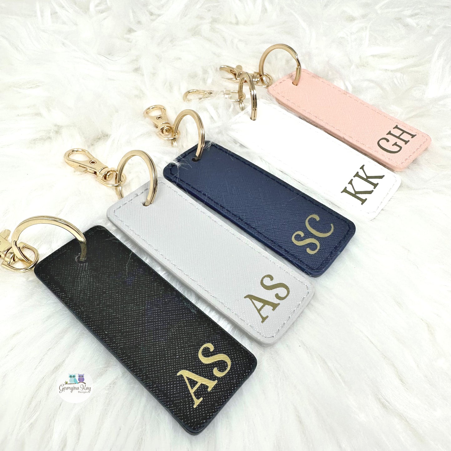 Set of personalized keychains with initials on a white background