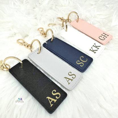 Set of personalized keychains with initials on a white background