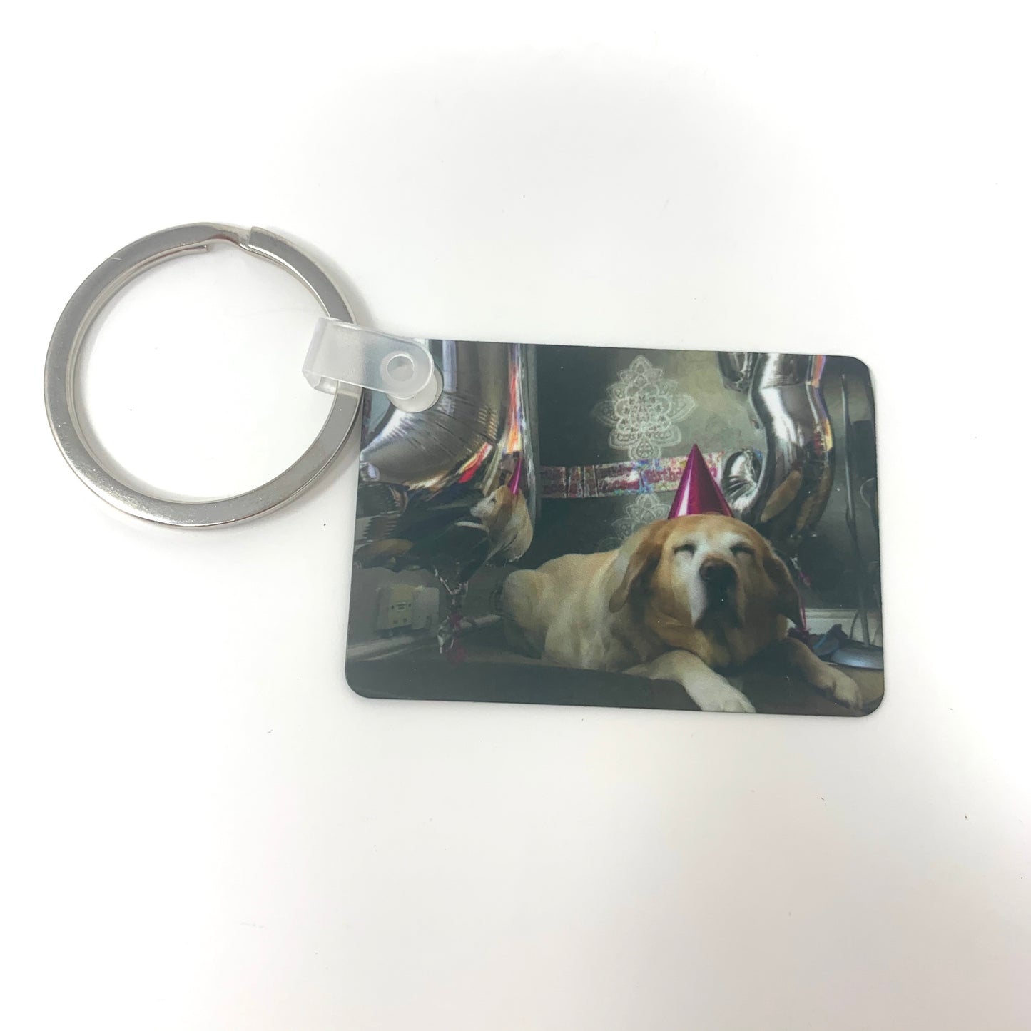 Keychain with a dog in a car on a white background