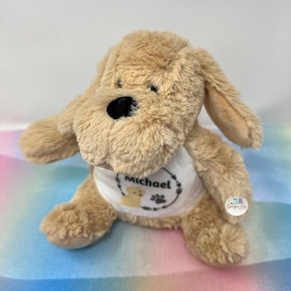 Plush dog toy with a white shirt on a colorful blanket