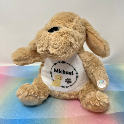Plush dog toy with a shirt labeled 'Michael' on a colorful blanket