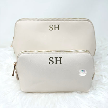 Beige makeup bag with 'SH' initials on a white background