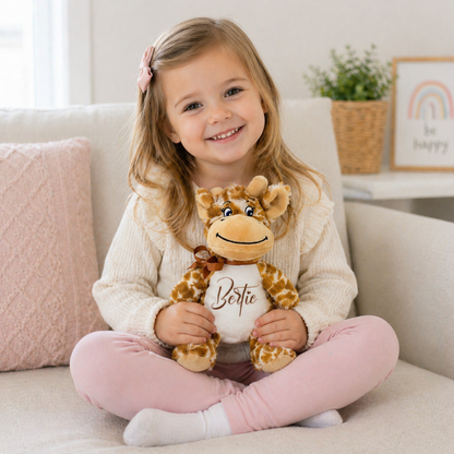 Child holding a stuffed giraffe toy named Bertie on a couch