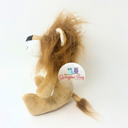 Plush lion toy with a visible brand logo on a white background