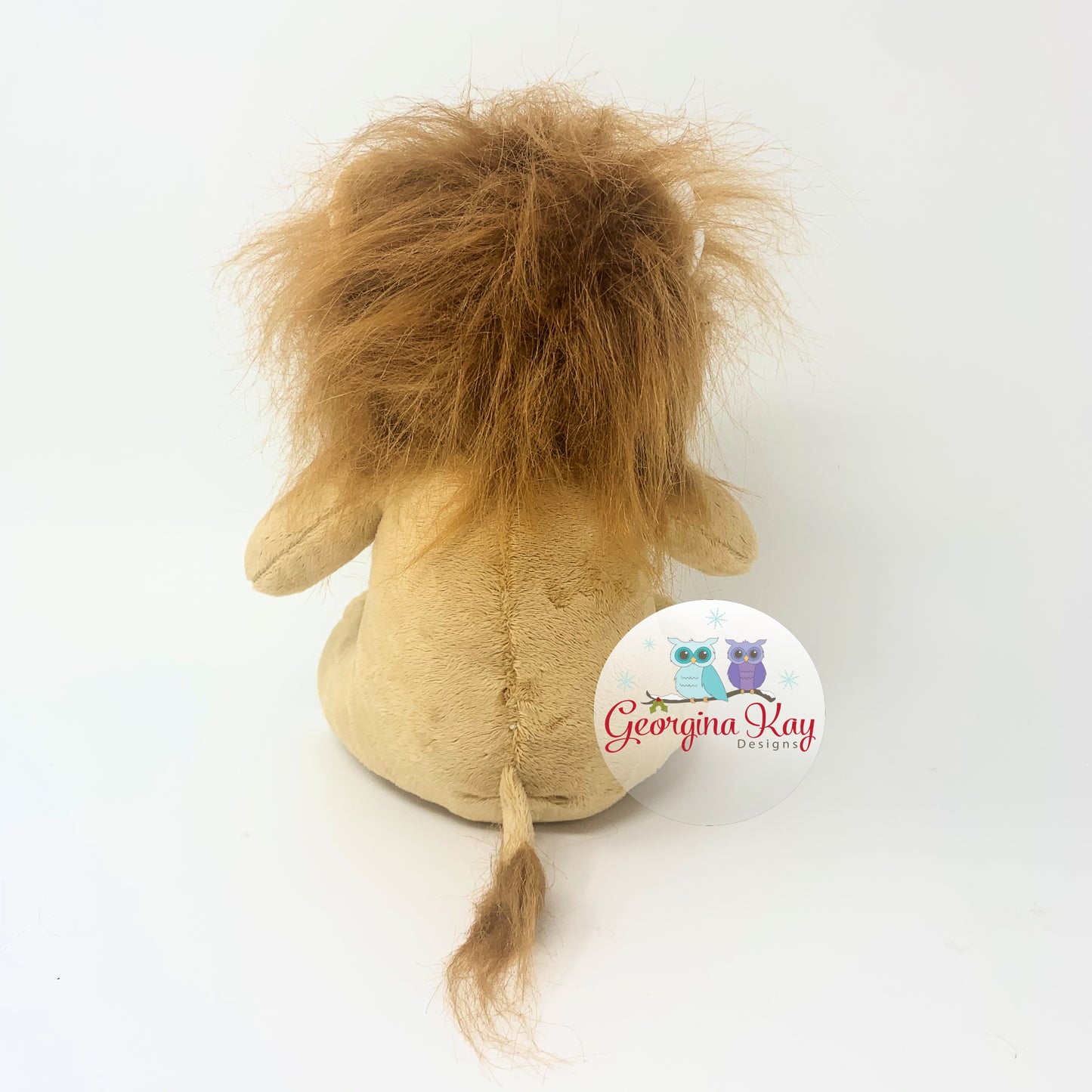Plush lion toy with a visible brand logo on a white background