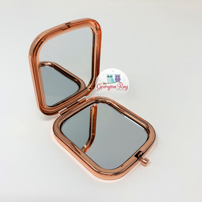 Rose gold compact mirror on a white background with 'Georgina Kay' branding.