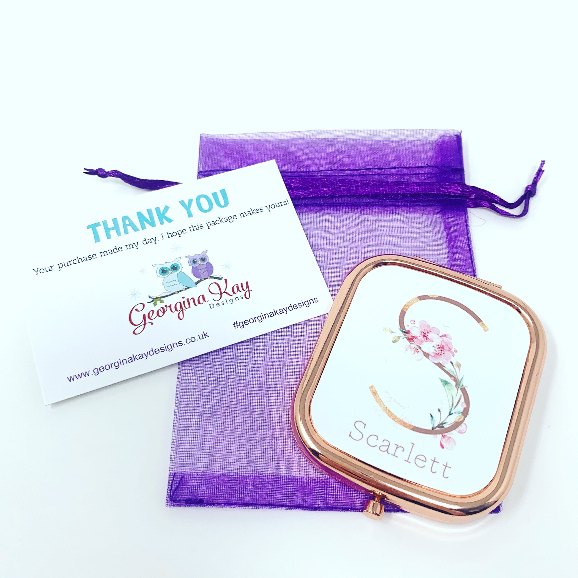 Compact mirror with floral design and 'Scarlett' text, placed on a purple drawstring bag with a 'Thank You' card from Georgina Kay Designs.